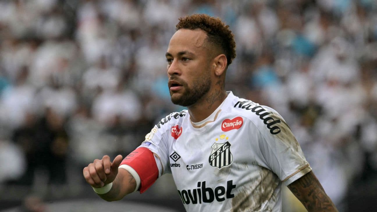 Neymar looks on.
