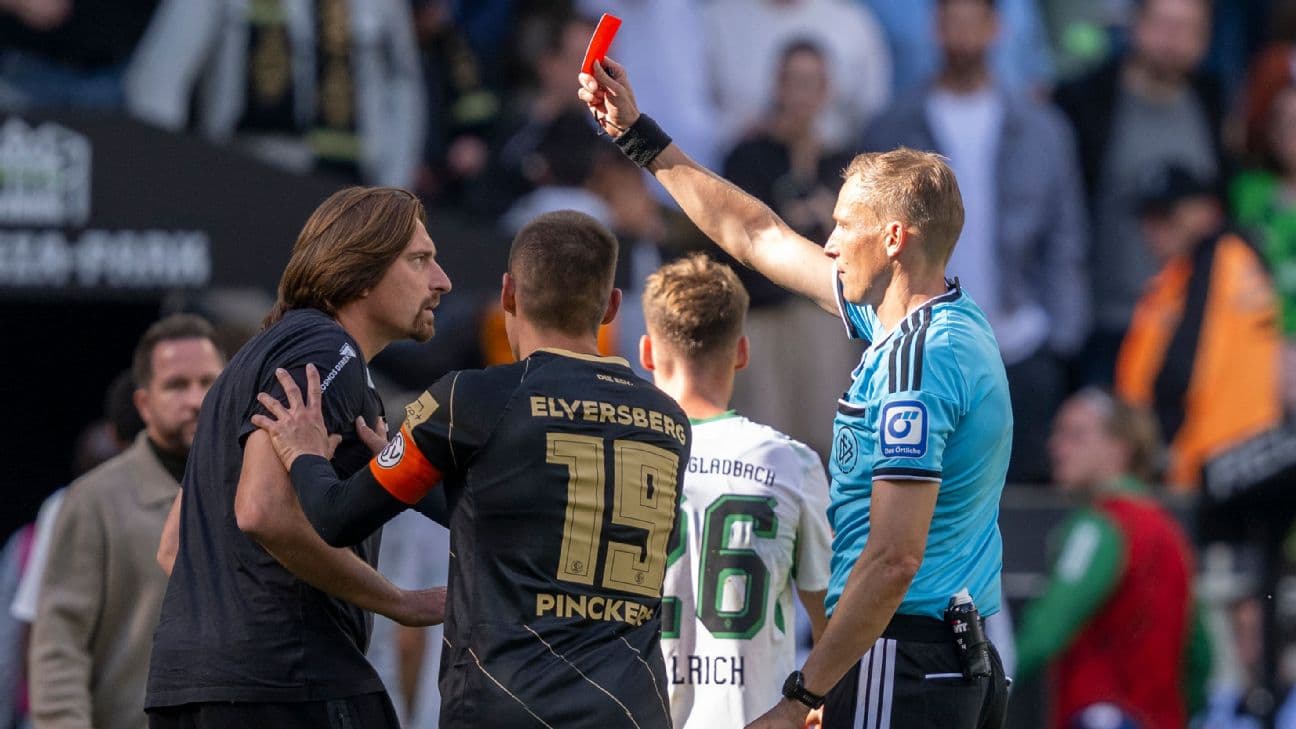 Men: Bundesliga, Borussia Mönchengladbach vs. SV Elversberg, Matchday 2, ista-Borussia-Park Stadium: Referee Martin Petersen (right) shows coach Vincent Wagner (SV 07 Elversberg) a yellow-red card.